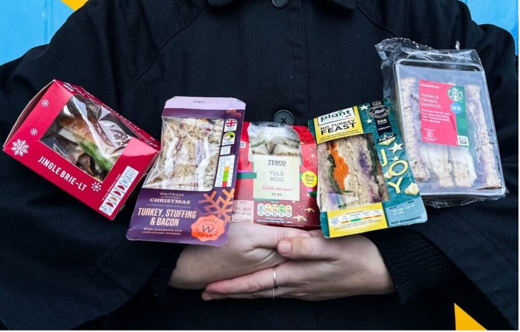 Selection of Christmas sandwiches from major retailers being held in the reviewers arms