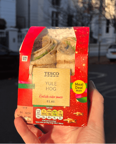 A hand holding the Tesco Yule Hog Sandwich from christmas 2023