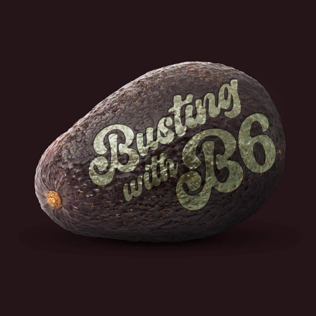 Image depicts an avocado laid on it's side, with text lasered into its skin. The text reads Busting with B6.